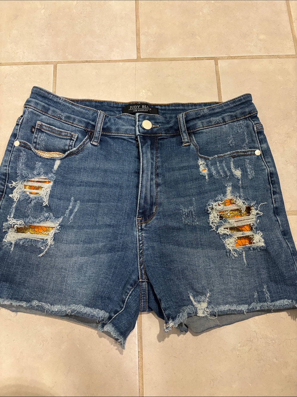 Judy Blue Medium Wash Ripped Denim Shorts with Orange Peek Through Floral Design
